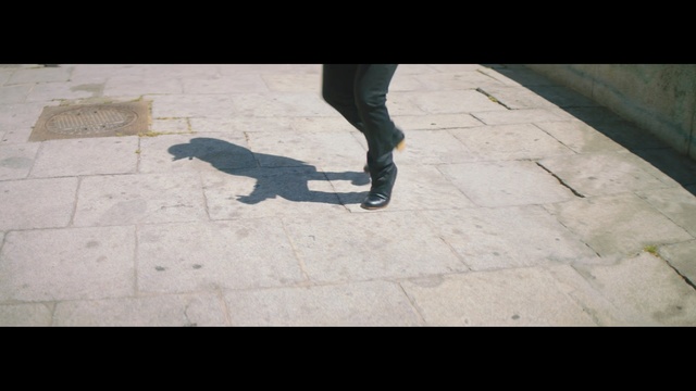 Video Reference: black, photograph, footwear, shadow, wall, snapshot, floor, leg, shoe, line, Person