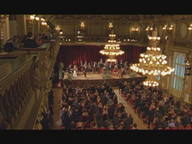 Video Reference: Auditorium, Stage, Crowd, Audience, Theatre, Concert hall, Performing arts center, Function hall, Building, Opera house, Person