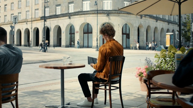 Video Reference: Sitting, Furniture, Architecture, Table, City, Building, Person