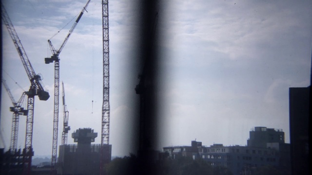 Video Reference: Sky, Atmospheric phenomenon, Crane, Atmosphere, Urban area, Cloud, Metropolitan area, City, Architecture, Skyscraper, Person
