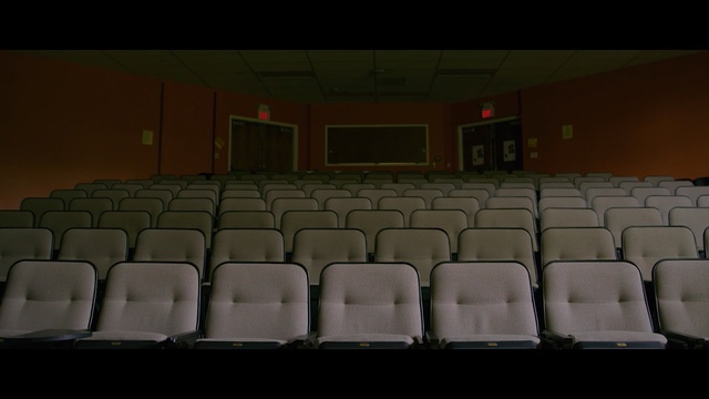 Video Reference: auditorium, light, theatre, movie theater, Person