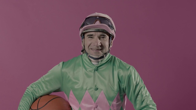Video Reference: Green, Pink, Head, Human, Outerwear, Photography, Personal protective equipment, Smile, Sleeve, T-shirt