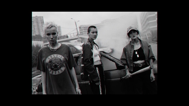 Video Reference: White, Photograph, Black-and-white, Monochrome, Snapshot, Photography, Monochrome photography, Standing, Fun, Crew, Person, Photo, Man, Posing, Racket, Woman, Holding, Player, Front, Black, Court, Wearing, People, Group, Young, Ball, Skiing, Playing, Room, Clothing, Text, Human face