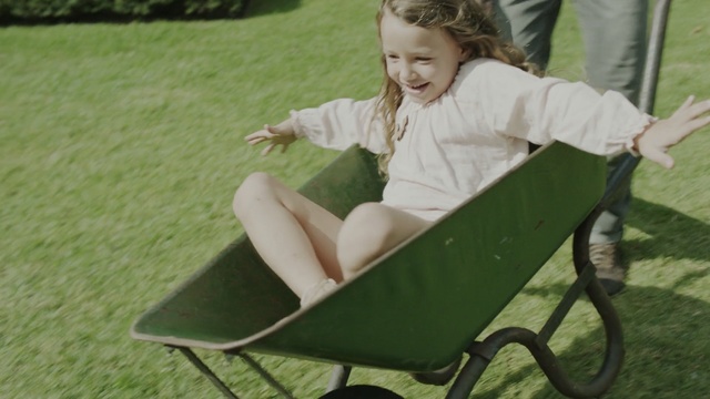 Video Reference: green, sitting, grass, lawn, child, plant, furniture, wheelbarrow, leisure, play