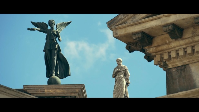 Video Reference: statue, monument, sky, sculpture, landmark, daytime, screenshot, tourist attraction, artwork, memorial, Person