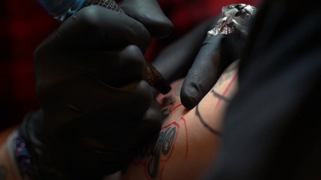 Video Reference: Tattoo, Skin, Hand, Flesh, Finger, Tattoo artist, Lip, Pain, Design, Mouth