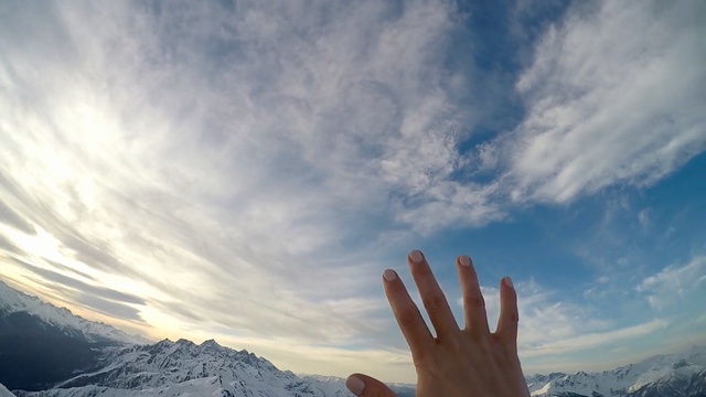 Video Reference: Sky, Cloud, Daytime, Hand, Atmosphere, Sunlight, Mountain, Cumulus, Meteorological phenomenon, Finger, Person