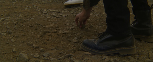 Video Reference: footwear, soil, shoe, outdoor shoe, foot, rock, grass, darkness, Person