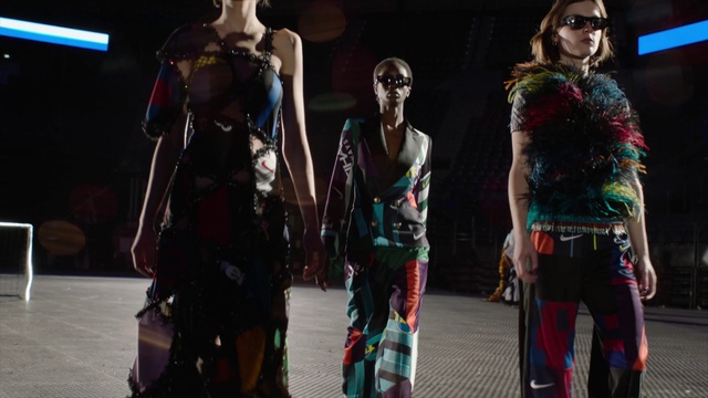 Video Reference: Fashion, Human, Fashion design, Performance, Dress, Event, Fashion show, Haute couture, Fictional character, Performance art, Person, Standing, Group, Holding, Man, Girl, Young, People, White, Skiing, Room, Clothing, Sunglasses, Dance, Woman, Sport, Human face, Footwear