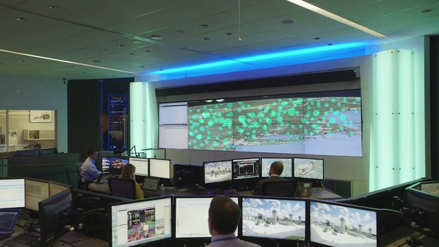 Video Reference: Building, Interior design, Room, Technology, Display device, Office, Ceiling, Electronic device, Architecture, Multimedia