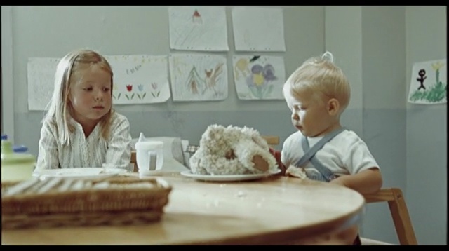 Video Reference: child, room, baking, icing, toddler, sitting, infant, product, eating, cake decorating, Person