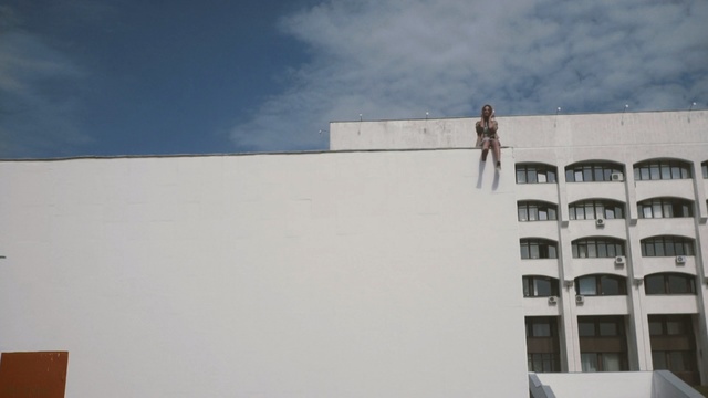Video Reference: Sky, Blue, Wall, Daytime, Architecture, Roof, Line, Cloud, Facade, Material property, Person