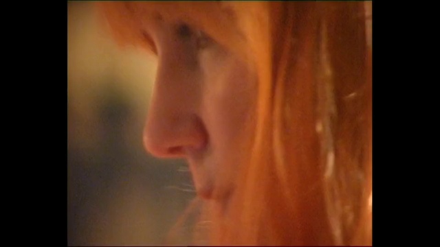 Video Reference: Face, Hair, Nose, Lip, Skin, Portrait, Eyebrow, Close-up, Chin, Cheek, Person, Indoor, Looking, Front, Staring, Camera, Sitting, Food, Mirror, Young, Smiling, Close, Standing, Woman, Glass, Teeth, Reflection, Shirt, Brushing, Wearing, Man, Black, White, Screen, Table, Red, Holding, Mouth, Room, Blurry, Blue, Human face, Eyes, Blur