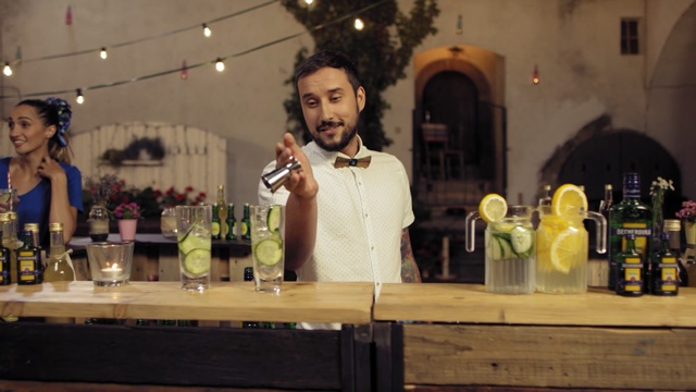 Video Reference: distilled beverage, drink, liqueur, alcoholic beverage, alcohol, wine, bottle, bar, Person