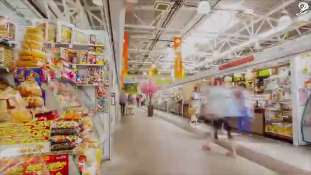 Video Reference: retail, store, aisle, snacks, candy, supermarket, shopping, indoor, customers, shelves, packaged food, convenience store, blurred motion, interior, commercial, market