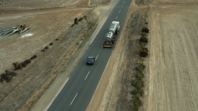 Video Reference: road, lane, asphalt, highway, mode of transport, infrastructure, road surface, race track, aerial photography, shoulder