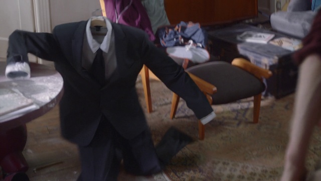 Video Reference: Suit, Human, Room, Adaptation, Formal wear, Sitting, Furniture, Flooring