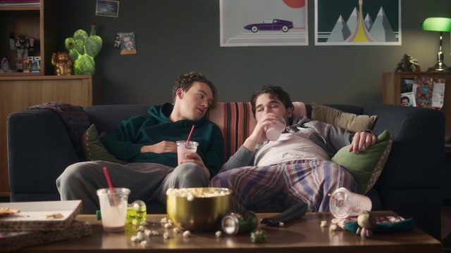 Video Reference: Green, Sitting, Couch, Furniture, Conversation, Table, Room, Living room, Alcohol, Drink