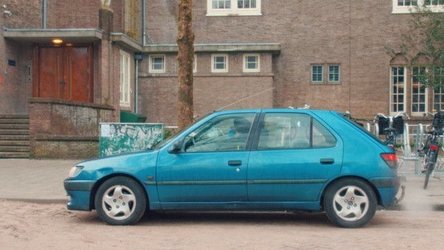 Video Reference: car, land vehicle, vehicle, family car, vehicle door, peugeot, hatchback, city car, peugeot 306, road, Person