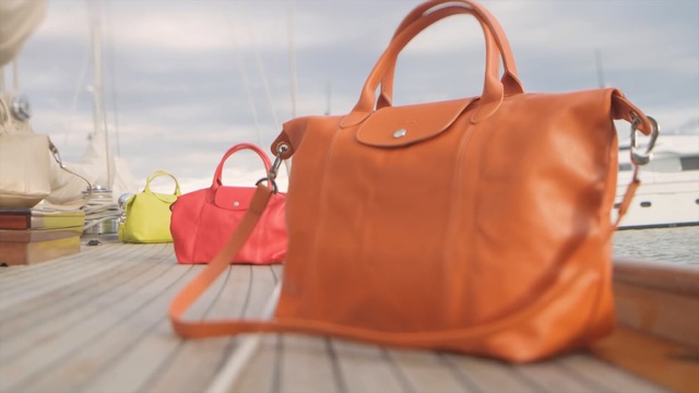 Video Reference: Handbag, Bag, Leather, Orange, Fashion accessory, Tan, Shoulder bag, Brown, Peach, Material property