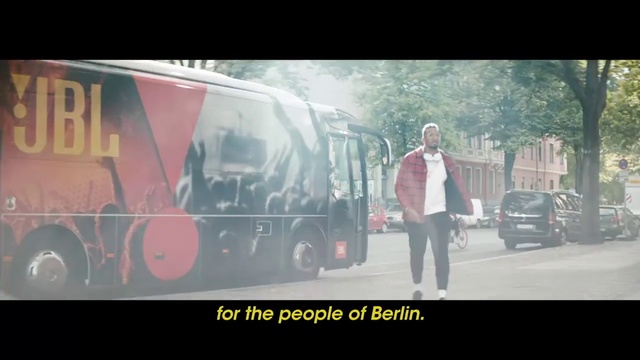 Video Reference: Mode of transport, Transport, Text, Commercial vehicle, Snapshot, Font, Vehicle, Photo caption, Automotive exterior, Automotive design, Person, Road, Outdoor, Bus, Photo, Truck, Street, Man, Driving, City, Standing, Large, Red, Parked, Woman, People, Mirror, Riding, Fire, Car, Double, White, Land vehicle, Clothing, Van