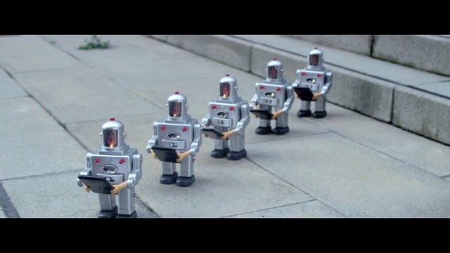 Video Reference: Robot, Asphalt, Marching percussion, Musician, Toy, Fictional character, Marching band, Action figure