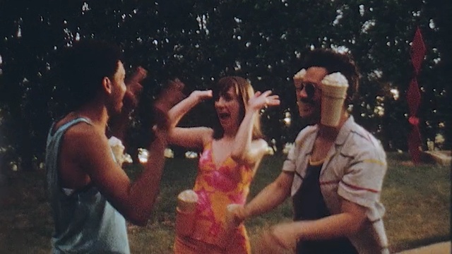 Video Reference: Fun, Event, Photography, Person, Outdoor, Man, Standing, Holding, Woman, Playing, People, Front, Game, Group, White, Young, Table, Cake, Court, Player, Ball, Video, Dance, Smile, Clothing, Human face, Crowd