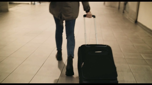 Video Reference: white, black, standing, floor, snapshot, leg, flooring, product, bag, human leg, Person