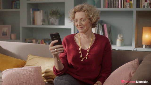 Video Reference: Sitting, Electronic device, Technology, Room, Neck, Furniture, Gadget, Living room, Couch, Interior design, Person