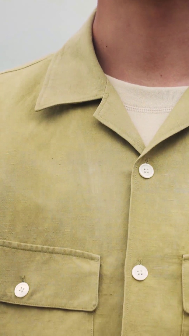 Video Reference: Clothing, Collar, Button, Khaki, Beige, Outerwear, Sleeve, Trench coat, Coat, Neck