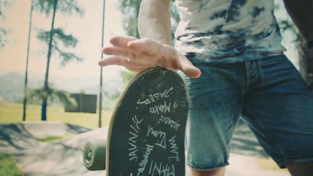 Video Reference: Green, Finger, Hand, Tree, Arm, Cool, Leg, Jeans, Photography, Skateboard, Person, Outdoor, Holding, Young, Man, Woman, Board, Riding, Boy, Black, Shirt, Food, Standing, Table, Doing, Game, White, Street, Handwriting