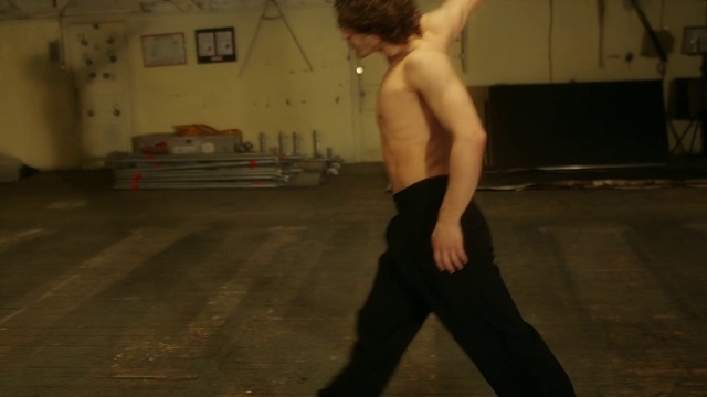 Video Reference: Arm, Standing, Male, Barechested, Dance, Shoulder, Muscle, Leg, Joint, Human body, Person, Young, Woman, Man, Holding, Wearing, Black, Board, Riding, Shirt, Walking, Street, White, Doing, Playing, Kitchen, Game, Floor, Physical fitness, Yoga, Hip, Combat sport, Knee, Nude, Yoga pant