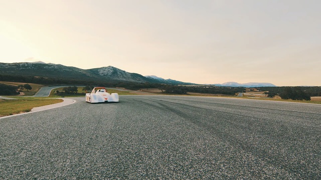 Video Reference: Asphalt, Road, Road surface, Sky, Vehicle, Car, Road trip, Race track, Line, Infrastructure