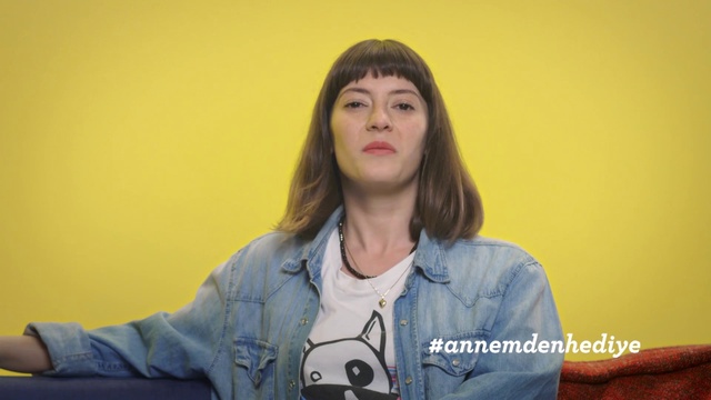 Video Reference: Chin, Cheek, Long hair, Gesture, Mouth, Outerwear, Sitting, Neck