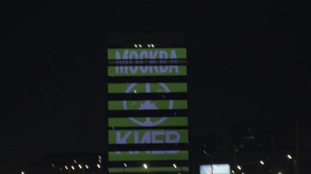 Video Reference: green, night, mode of transport, darkness, technology, display device, light, sky, electronic signage, atmosphere