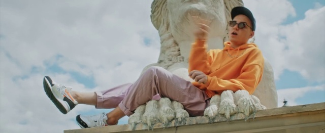 Video Reference: Guru, Temple, Statue, Leisure, Art, Person, Outdoor, Man, Sitting, Woman, Holding, Orange, Riding, Young, Water, White, Boat, Playing, Standing, Sky, Baby, Human face, Clothing, Toddler