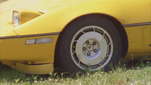 Video Reference: motor vehicle, alloy wheel, car, wheel, yellow, tire, automotive tire, rim, mode of transport, automotive exterior, Person