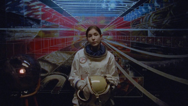 Video Reference: Space, Art, Person, Indoor, Holding, Small, Sitting, Man, Building, Umbrella, Young, Black, Standing, Boy, Wearing, Computer, Room, White, Phone, Human face, Clothing, Woman