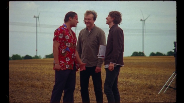 Video Reference: Standing, Grass, Fun, Friendship, Tree, Adaptation, Photography, Landscape, Plant, Soil, Person, Outdoor, Man, Field, Front, People, Group, Playing, Holding, Game, Woman, Young, Suit, Large, Airplane, Wearing, Plane, Player, Red, Ball, Soccer, Kite, Frisbee, Sign, Room, Flying, Clothing, Sky, Smile, Human face