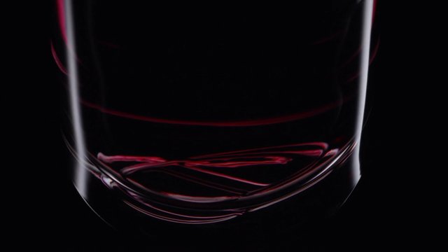 Video Reference: glass, drinking glass, red liquid, liquid, close-up, black background, transparent, abstract, minimal, reflection, still life, beverage, container
