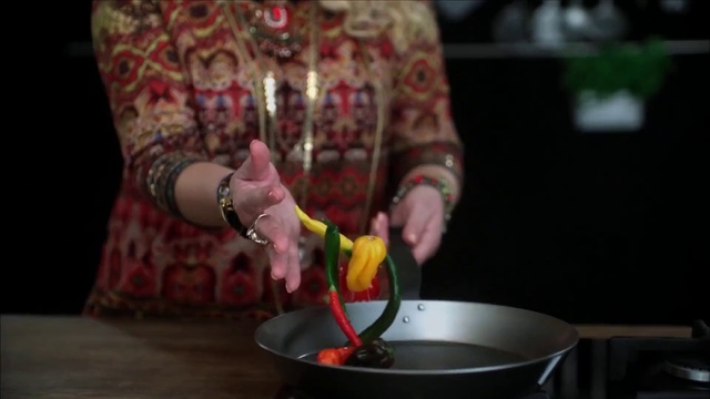 Video Reference: Food, Hand, Plant, Person, Indoor, Table, Holding, Young, Front, Small, Cake, Man, Little, Using, Shirt, Standing, Wearing, Boy, Bowl, Plate, Woman, Cut, Kitchen, Pan, Room
