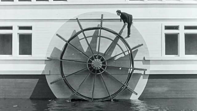 Video Reference: wheel, bicycle wheel, black and white, spoke, rim, automotive tire, tire, structure, monochrome photography, automotive wheel system, Person