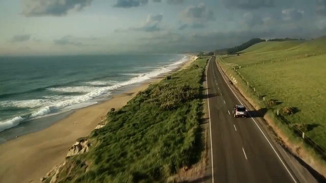 Video Reference: road, coast, mode of transport, highway, horizon, shore, sky, terrain, road trip, promontory