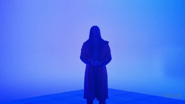 Video Reference: Blue, Cobalt blue, Sky, Purple, Standing, Electric blue, Violet, Shadow, Statue, Outdoor, Person, Front, Man, Looking, Wearing, Snow, Water, Holding, Woman, Hill, Red, Young, Shirt, Sign, Beach, Flying, Abstract, Silhouette