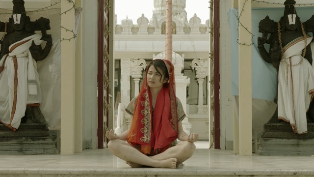 Video Reference: religion, religious institute, temple, place of worship, outerwear, statue, tourist attraction, girl, window, sculpture, Person