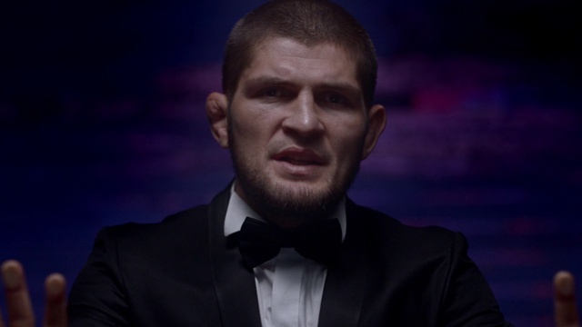Video Reference: Chin, Facial hair, Forehead, Suit, Cheek, Human, Formal wear, White-collar worker, Beard, Official