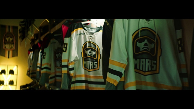 Video Reference: Sportswear, T-shirt, Jersey, Jacket, Sleeve, Font, Textile, Top, Liqueur, Darkness