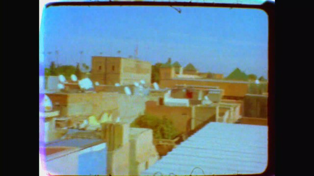 Video Reference: rooftops, urban, buildings, satellite dishes, cityscape, sky, architecture, vintage, blurry, outdoor, residential, middle east, daytime