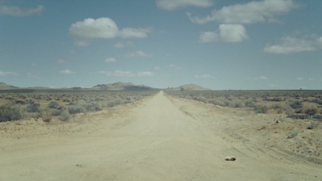 Video Reference: Road, Sky, Natural environment, Ecoregion, Cloud, Sand, Dirt road, Wadi, Road trip, Horizon
