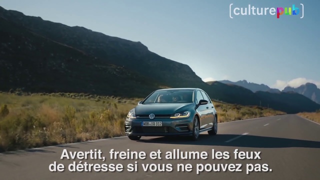 Video Reference: Land vehicle, Vehicle, Car, Mid-size car, Volkswagen, Full-size car, Automotive design, Luxury vehicle, Hot hatch, Outdoor, Mountain, Road, Scene, Highway, Street, Sign, Traffic, Truck, Man, Driving, Riding, Motorcycle, Cross, Green, Side, Sitting, Intersection, Parked, Country, Stop, Light, Standing, White, Hill, Runway, Board, Text, Sky, Wheel, Way, Automotive, Tire, Hatchback